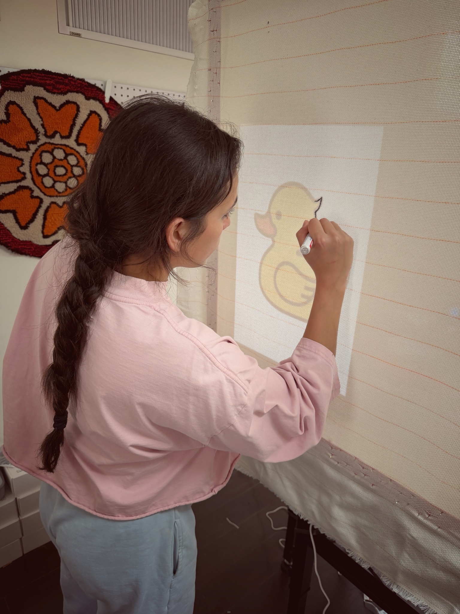 Projecting a design onto tufting fabric